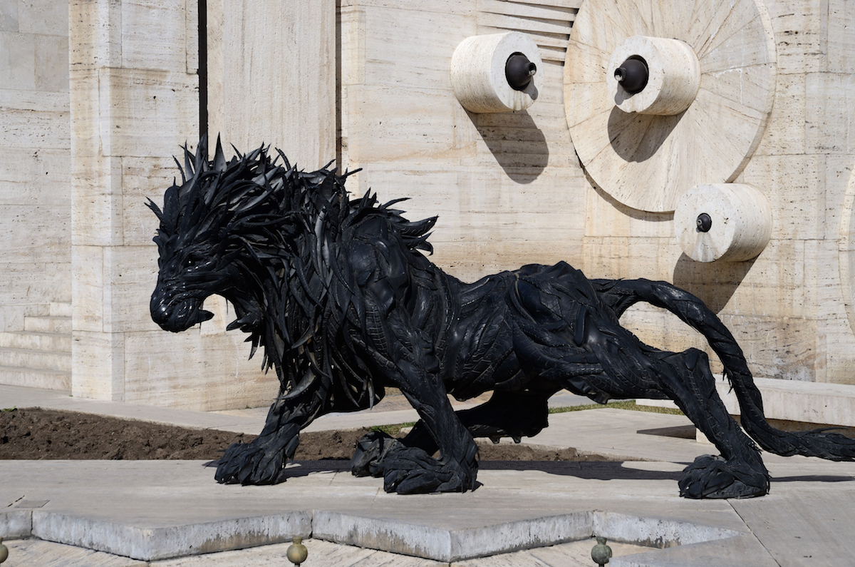 Lion art statue made from old car tyres near Yerevan Cascade giant stairway in Yerevan