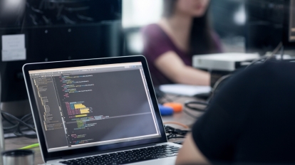 Asian Outsource Developer Team Sitting At Desk Working Laptop Computer Mobile Application Software Real Office