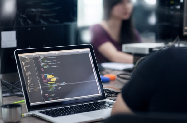 Asian Outsource Developer Team Sitting At Desk Working Laptop Computer Mobile Application Software Real Office