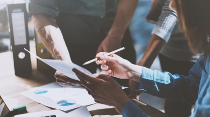 Photo team work process, holding contract hand, signs documents. Account managers young crew works with startup project.New idea presentation, analyze marketing reports.Blurred, film effect, horizontal.