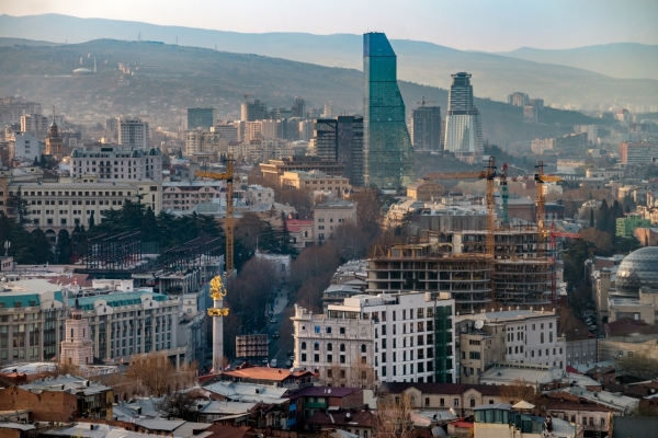 Panorama of Tbilisi, Georgia in sunset rays. Vivid, saturated, splittoned image.