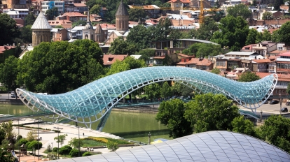 TBILISI GEORGIA Jul. 18 2017: Bridge of Peace is a bow-shaped pedestrian bridge a steel and glass construction over the Kura River in downtown Tbilisi capital of Georgia
