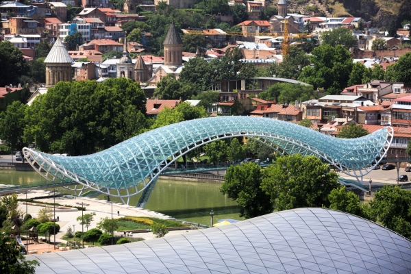 TBILISI GEORGIA Jul. 18 2017: Bridge of Peace is a bow-shaped pedestrian bridge a steel and glass construction over the Kura River in downtown Tbilisi capital of Georgia