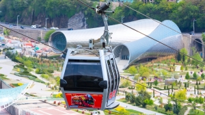 Tbilisi, Georgia - April 29, 2017: Tbilisi red cable car fulicular cabin and aerial city skyline panoramic view