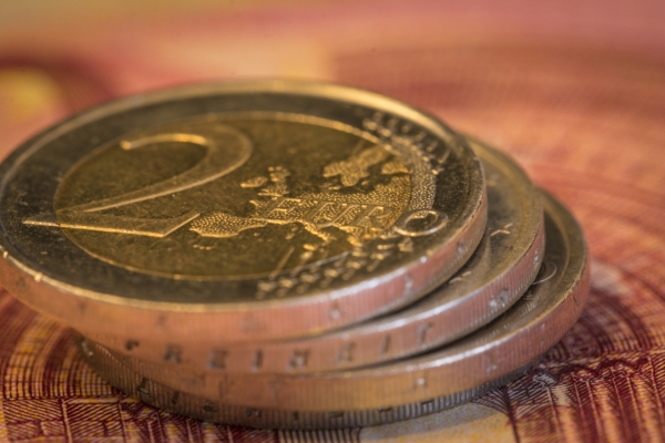 Euro money: Macro view of euro coin and bill. Suitable for financial, monetary, euro or European Union concepts and ideas