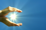 hand sun and blue sky with copyspace showing freedom or solar power concept