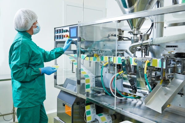 pharmaceutical factory woman worker operating production line at pharmacy industry manufacture factory