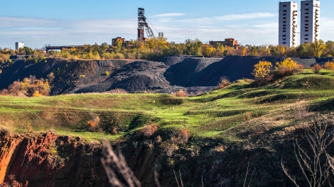Landscape with two mine head frames . Ukraine, Kryvyi Rih, Iron-ore mine Gvardeiskaya. An autumn sunny day with blue sky. Complex for Mining
