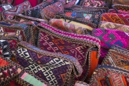 Bags headgear boxes made of traditional fabrics of Armenian patterns and colors lying on the stalls at the Yerevan market in Armenia