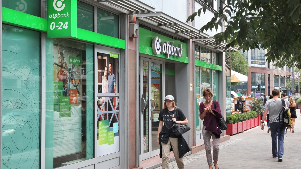 BUDAPEST HUNGARY - JUNE 22 2014: People walk by OTP Bank in Budapest. OTP is the biggest commercial Hungarian bank with 1500 branches in 9 countries.