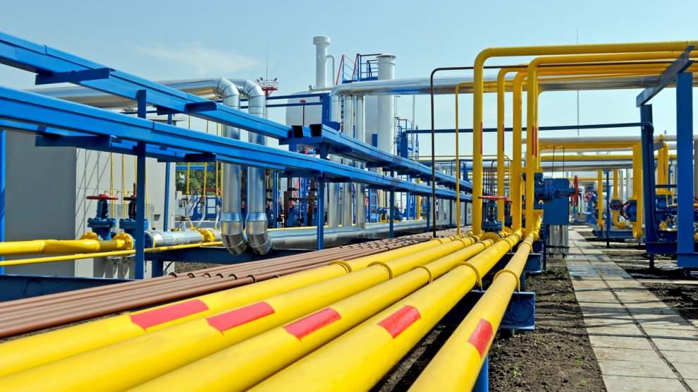 Yellow gas pipes in natural gas treatment plant in bright sunny summer day