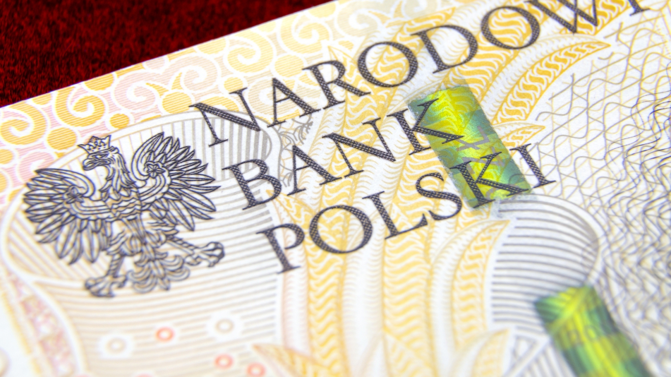 Money of National Bank of Poland. Polish zloty banknote on red velvet background; Macro photo; Depth of field