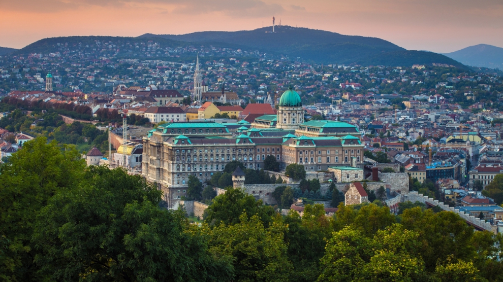 Budapest Hungary - Panoramic skyline view of the famous Buda Castle Royal Palace with the Buda Hills and Matthias Church at background at sunset