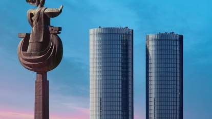 Riga Latvia - May 04 2017: Sculpture of Daugava and view to the Modern glass skyscrapers. Two round residential Z-Towers in the city center. Riga Latvia