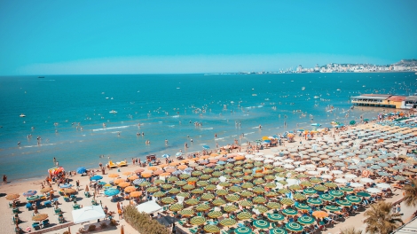 Sunny day and panoramic view to Durres beach. Blue sky and water of Adriatic Sea.