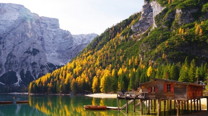 Amazing view of Braies Lake - Lago di Braies - with autumn forest and mountains reflected in surface lake water, Dolomites, Italy, Europe