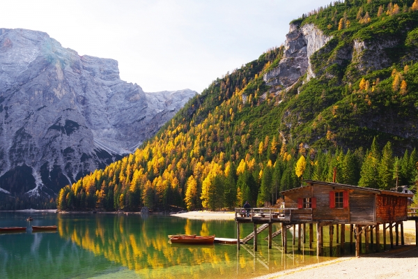 Amazing view of Braies Lake - Lago di Braies - with autumn forest and mountains reflected in surface lake water, Dolomites, Italy, Europe