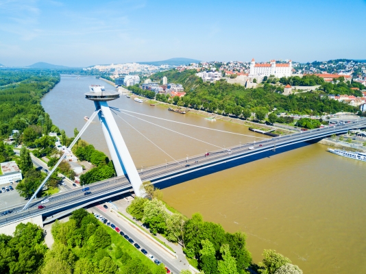 SNP New Bridge through Danude river aerial panoramic view in Bratislava. Bratislava is a capital of Slovakia.