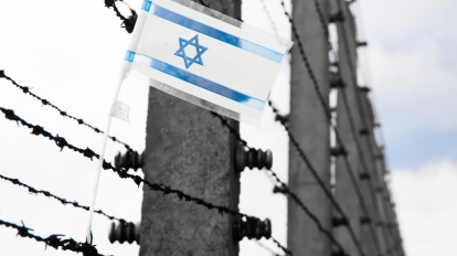 Small flag of Israel hanging on the barbwire in concentration camp