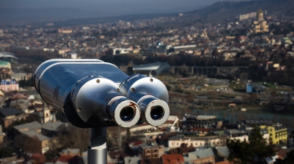 Georgia - Tbilisi. View to the most famous park and Peace bridge in Tbilisi, downtown in wintertime in sunny day. Mix of ancient and modern architecture of Old Tbilisi, capital city of Republic of Georgia in Caucasus region. 21.01.2018