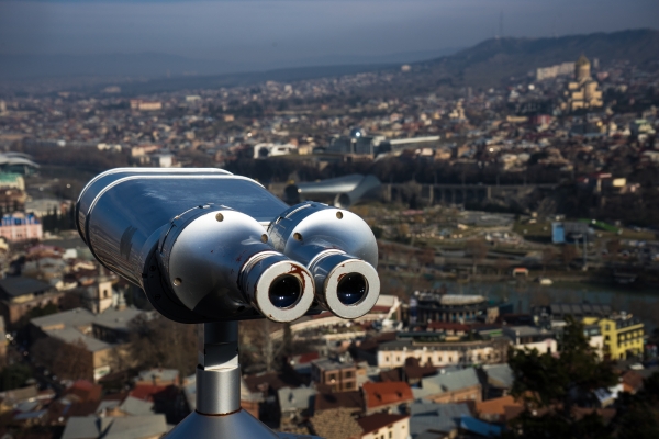 Georgia - Tbilisi. View to the most famous park and Peace bridge in Tbilisi, downtown in wintertime in sunny day. Mix of ancient and modern architecture of Old Tbilisi, capital city of Republic of Georgia in Caucasus region. 21.01.2018