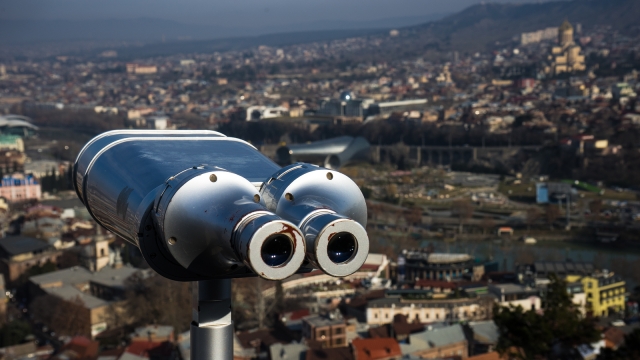 Georgia - Tbilisi. View to the most famous park and Peace bridge in Tbilisi, downtown in wintertime in sunny day. Mix of ancient and modern architecture of Old Tbilisi, capital city of Republic of Georgia in Caucasus region. 21.01.2018