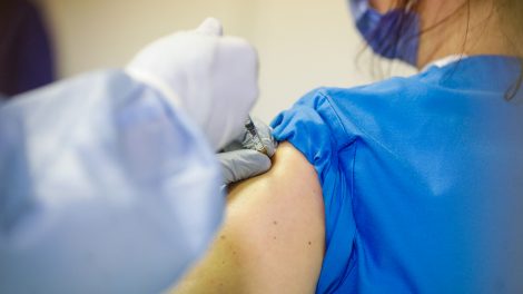 A health worker in Romania receives a vaccination against Covid-19.