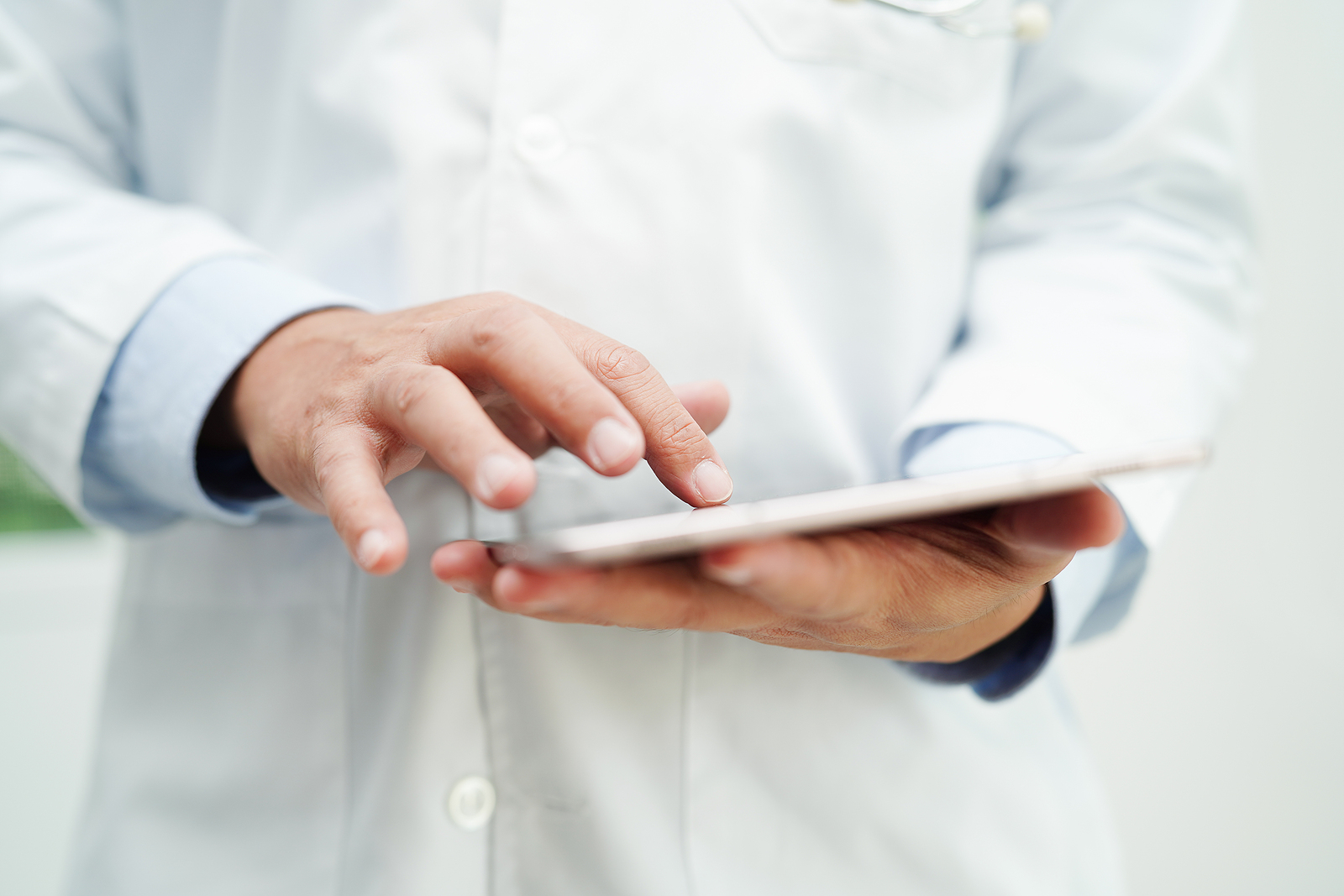 bigstock-Asian-Man-Doctor-Using-Tablet–478518479